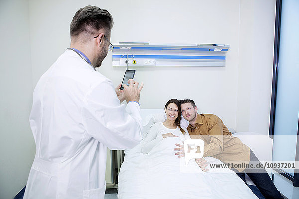 Doctor taking a picture of patient and boyfriend