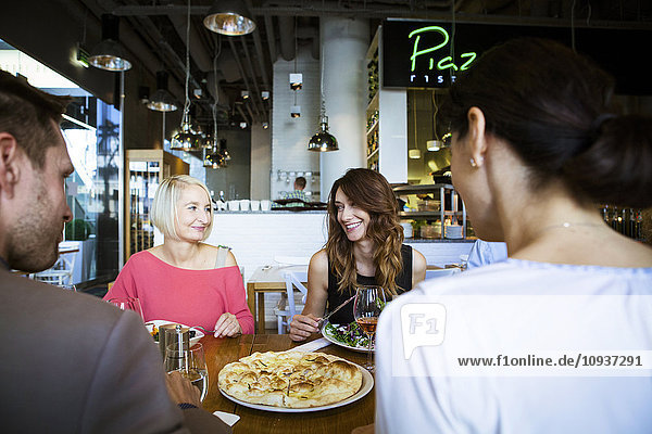 Group of friends celebrating in restaurant