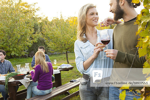 Group of friends drinking wine on garden party