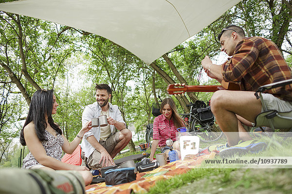 Group of friends relaxing at campsite
