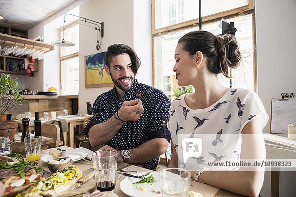 Young couple enjoying lunch at restaurant