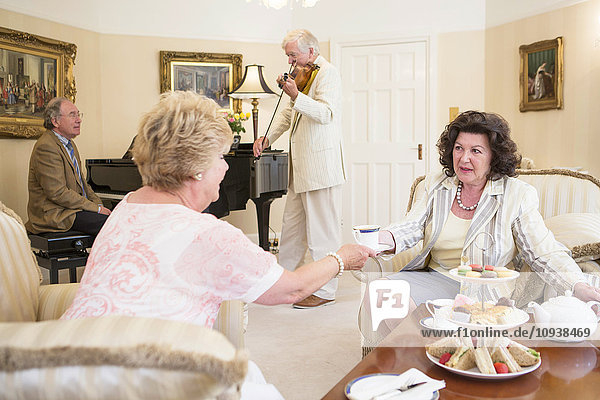 Tea party with music performance in background