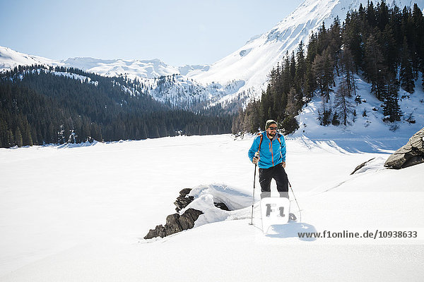 Man snowshoeing in Alpine winter landscape