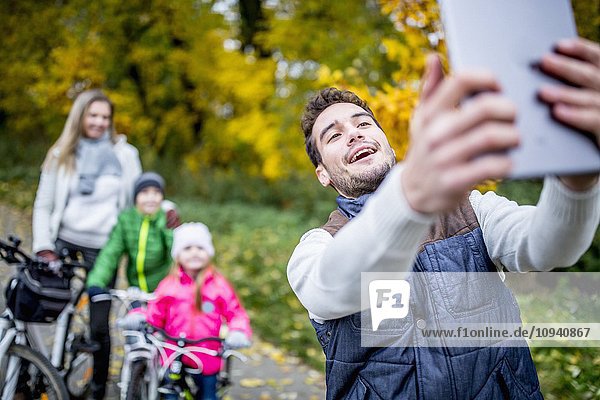 Man taking a photo of family