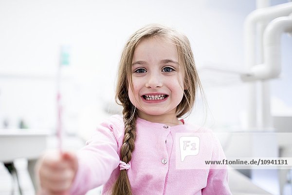 Girl holding toothbrush