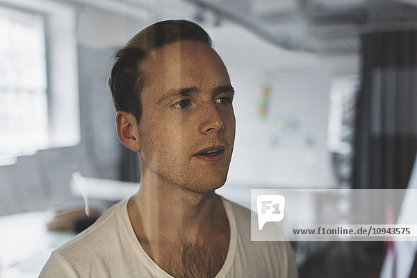 Close-up of businessman looking away in creative office
