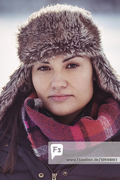 Portrait of confident woman wearing fur hat