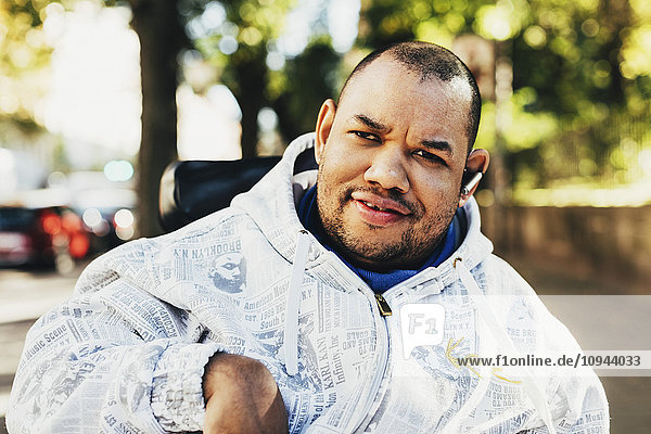 Portrait of happy disabled man wearing jacket outdoors