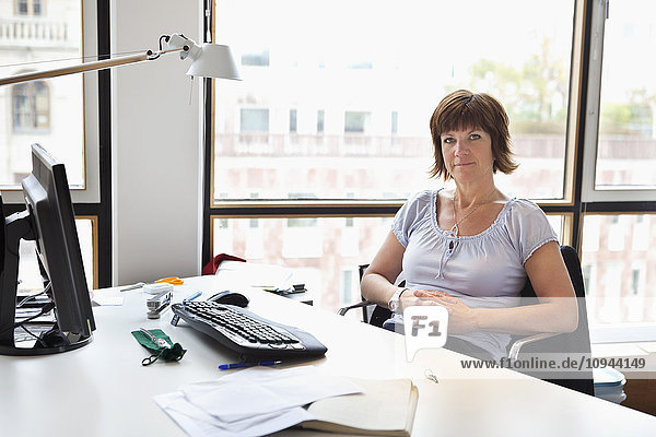 Portrait of mature business woman sitting in office