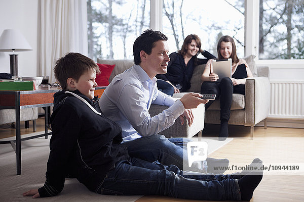Family watching TV together in living room