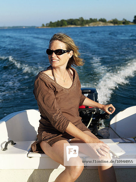 Woman sitting in motorboat