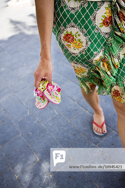 Italy  woman holding flip-flops