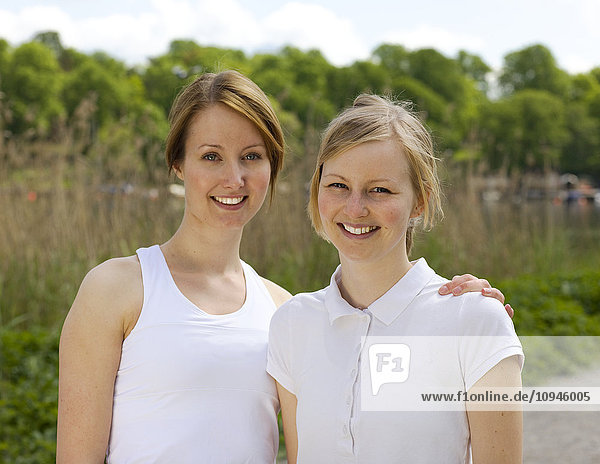 Two young women smiling,  portrait