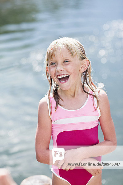 Young girl in swimsuit laughing