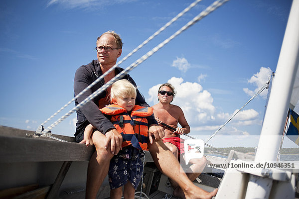 Father and son relaxing on boat