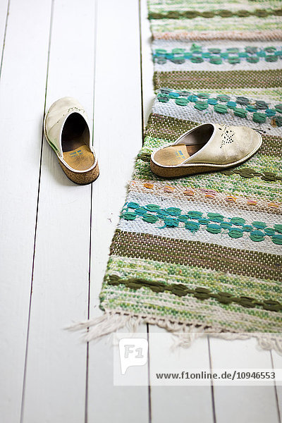Slippers on wooden floor with rugs