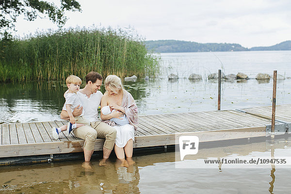 Family sitting on jetty