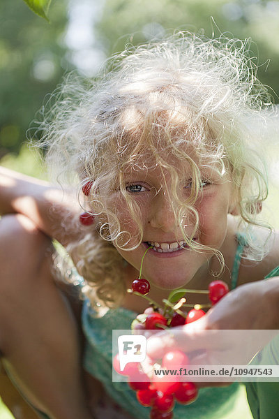 Girl holding branch with cherries