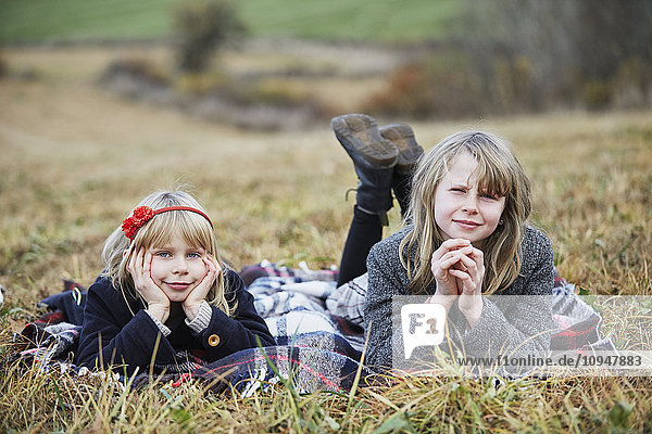 Smiling girls on meadow