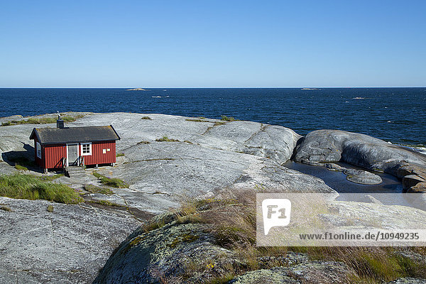 Wooden house on rocky coast