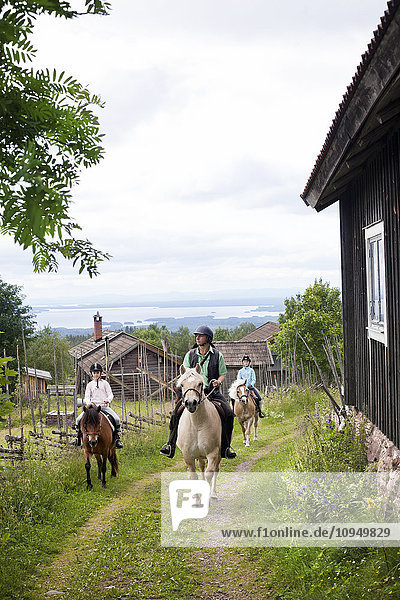 Horseback riding through village