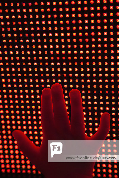 Childs hand touching LED display