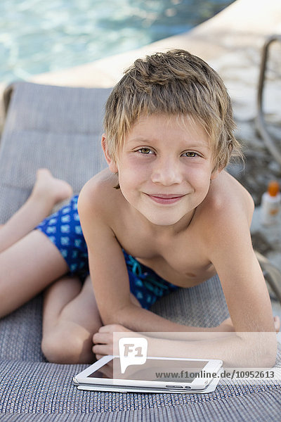Smiling boy with digital tablet