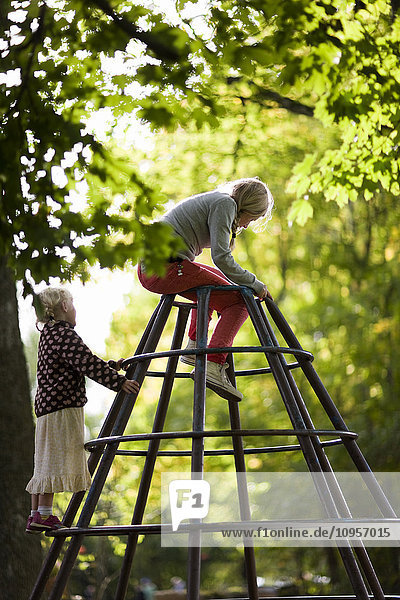 Two girls on a climbing frame  Sweden.