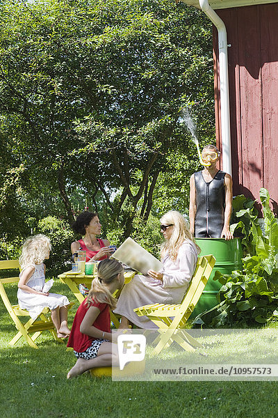 Family in a garden is taken by surprise  Sweden.
