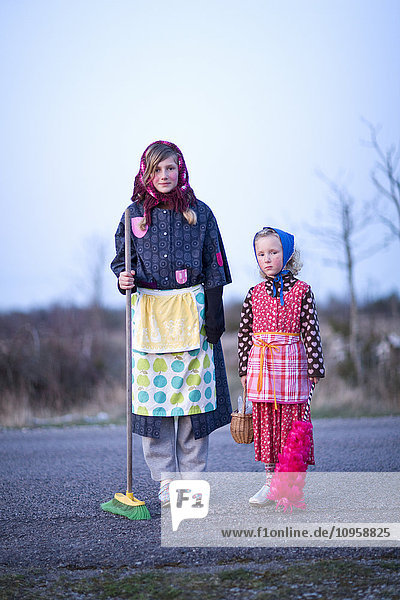 Portrait of two girls dressed up as Easter witches  Sweden.