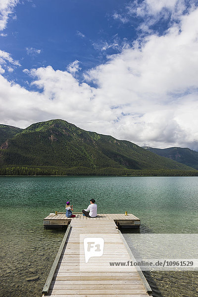 Mother and daughter on a dock at Muncho Lake Provincial Park  British Columbia  Canada  Summer