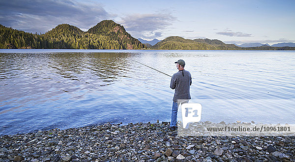 'Man fishing on the shore of Grice Bay  Pacific National Park; Vancouver Island  British Columbia  Canada'