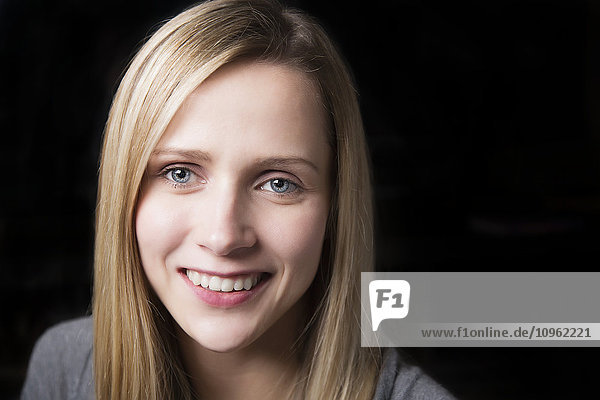 'Portrait of beautiful young woman on a black background; Spruce Grove  Alberta  Canada'