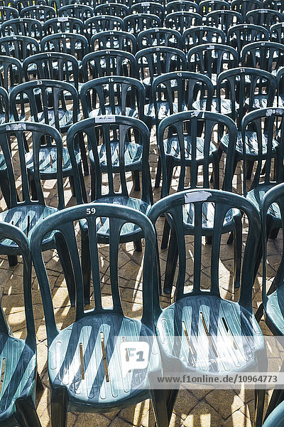 'Plastic green chairs lined up in rows; Malaga Province  Andalusia  Spain'