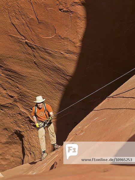 'Adventurer exploring a desert slot canyon  San Rafael Swell; Utah  United States of America'