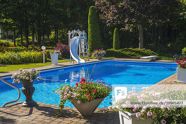 Schwimmbad mit Rutsche und Topfblumen auf der Veranda; Granby  Quebec  Kanada