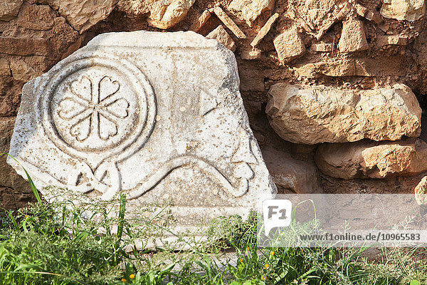 'Broken stone structure with a floral design; Delphi  Greece'