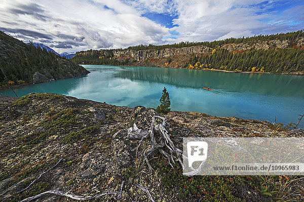 'Man kayaking in Atlin Lake; British Columbia Canada'