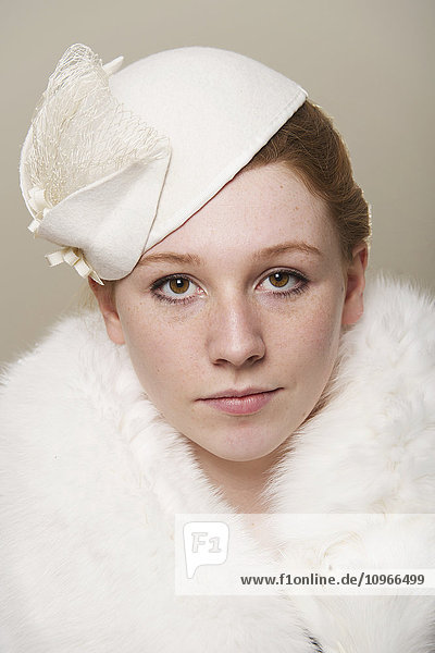 'Portrait of a young woman with red hair wearing a white hat and white fur coat; Caldecott  England'