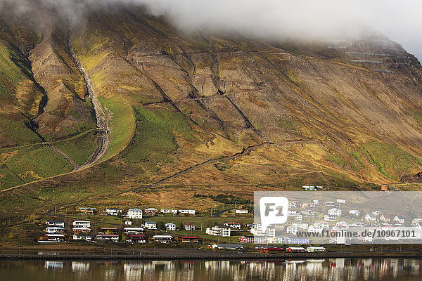 'Colorful houses in a village along the coast; Siglufjordur Iceland'