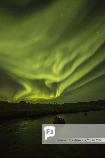 'Northern lights dancing over the Langanes Peninsula and the Atlantic Ocean; Iceland'