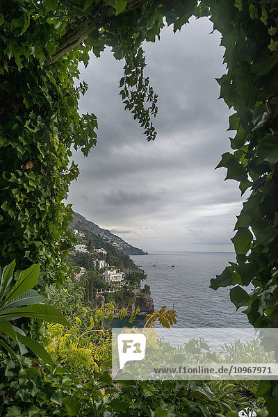 'Lush foliage framing the view of the Amalfi coastline; Positano  Campania  Italy'
