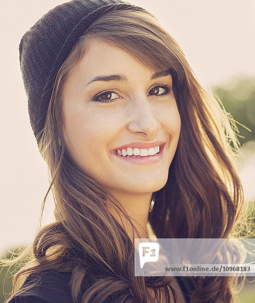 Fashion portrait of young beautiful woman outside bright warm sunny color tones
