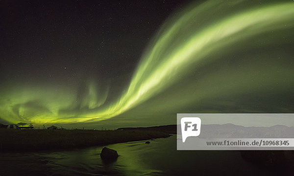 'Northern lights over a river and farm in Northeast Iceland; Iceland'