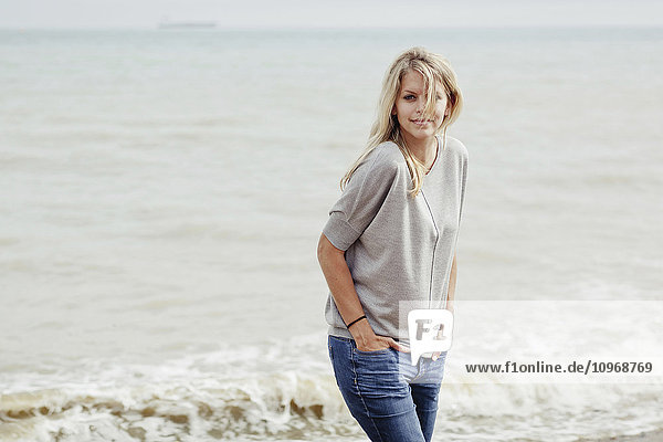 'Portrait of a young woman with long  blond hair at the Atlantic Ocean; Hastings  Sussex  England'