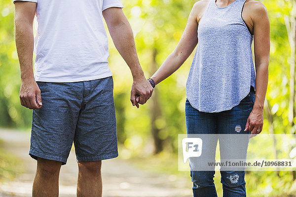 'A married couple spending quality time together walking in a park; Edmonton  Alberta  Canada'