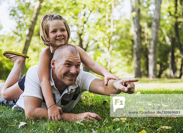 'A father spending quality time with his daughter in a park during a family outing; Edmonton  Alberta  Canada'