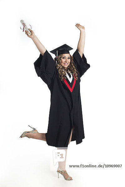 Junge Absolventin hält ihr Diplom in die Höhe  um ihren Abschluss zu feiern; Edmonton  Alberta  Kanada'.