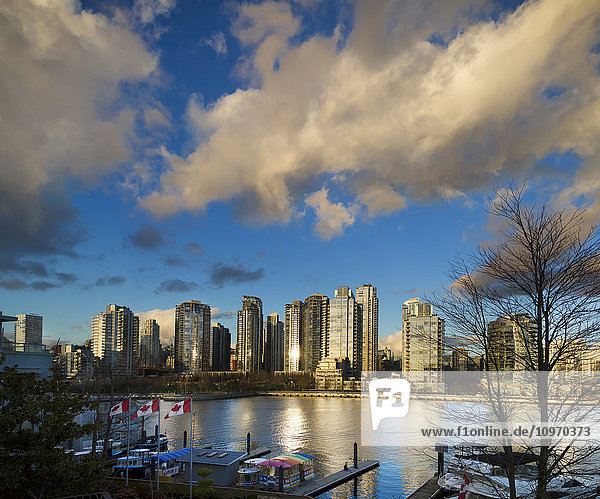 Kanada-Flaggen und Wohngebäude entlang der Uferpromenade  Granville Island; Vancouver  British Columbia  Kanada'.