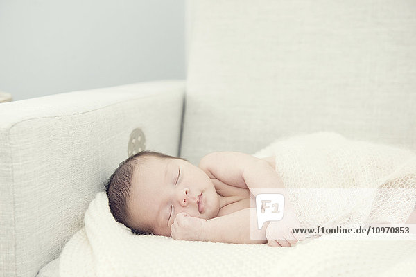 Neugeborenes Mädchen schlafend auf einem Schaukelstuhl mit einer Hand in der Nähe des Gesichts; Toronto  Ontario  Kanada'.